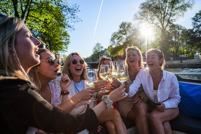 Amsterdam: Canal Booze Cruise with Unlimited Drinks Option - Boat comfort in rain: covered seating and what to bring