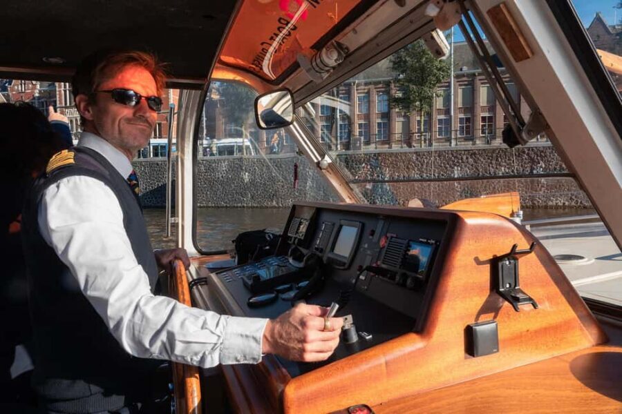 Amsterdam: Canal Cruise with Live Commentary & Audio Guide - Onboard experience: covered comfort, open-air moments, and real practical perks