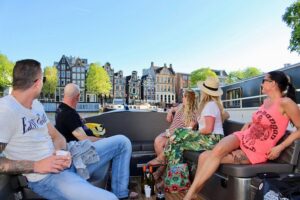 Amsterdam Canal Tour by Open Boat – 90 min Small Group Experience - Amstel River start: dancing houses and leaning buildings from the water