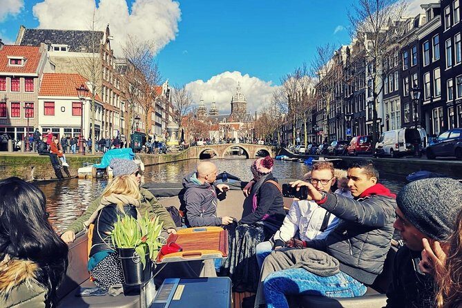 Amsterdam Canal Tour by Open Boat – 90 min Small Group Experience - Kolksluis and Nieuwmarkt square: locks, warehouses, and de Waag