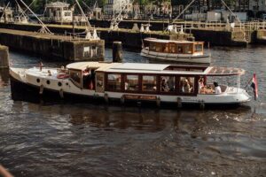 Amsterdam: Luxury Saloon Boat Cruise with Cocktails & Waffle - Boarding at the NH Krasnapolsky area: vouchers, easy timing, and calm logistics