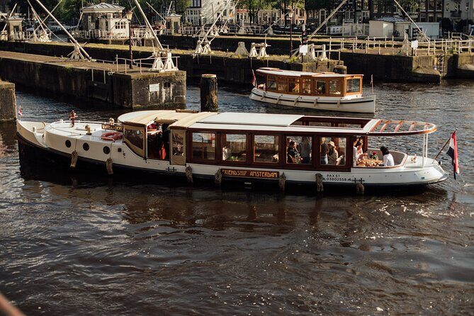 Amsterdam: Luxury Saloon Boat Cruise with Cocktails & Waffle - Boarding at the NH Krasnapolsky area: vouchers, easy timing, and calm logistics