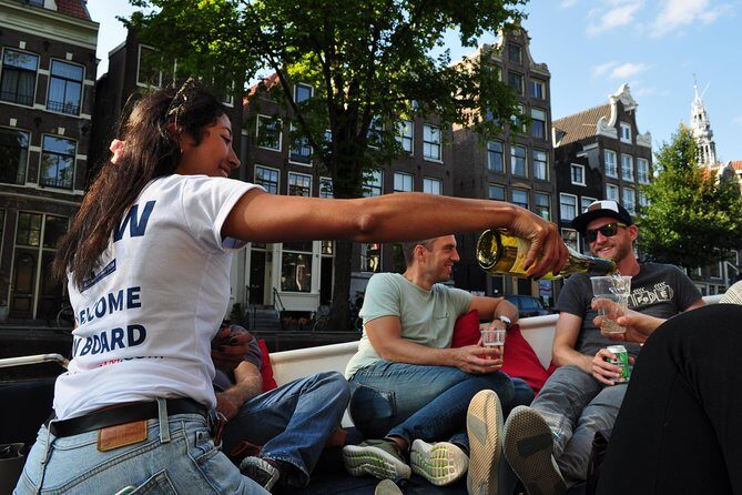 Amsterdam Open Boat Cruise with Live Guide and Two Drinks - Jordaan, Spiegelkwartier, and Neighborhood Energy You Can Feel