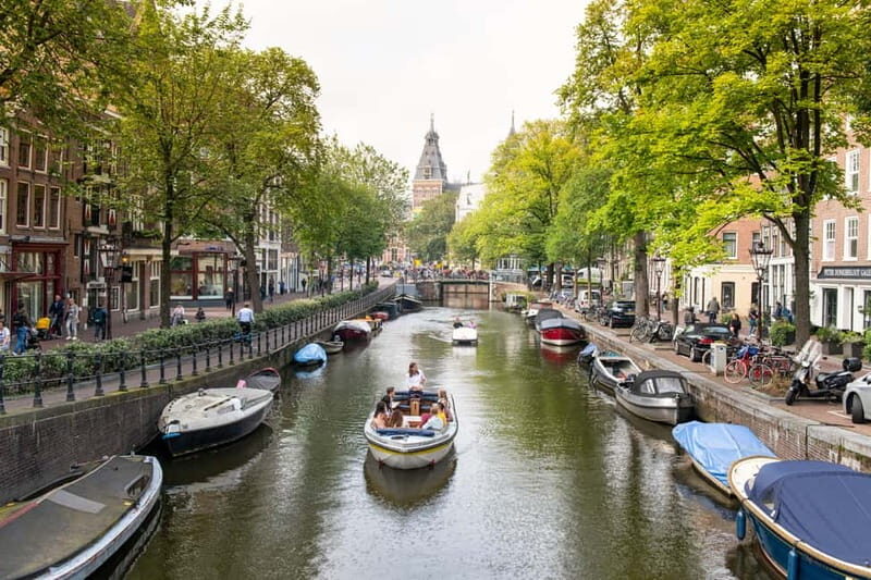 Amsterdam: Open Boat Tour of Canals with Expert Local Guide - The one-hour route: floating from Damrak to Prinsengracht