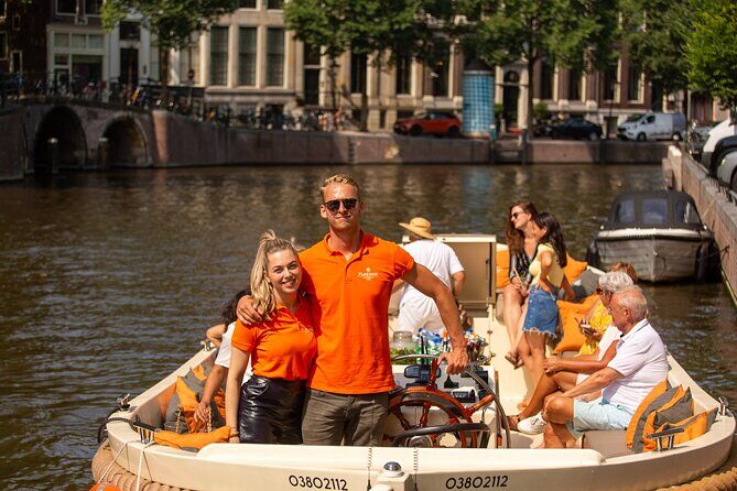 Amsterdam: Saloon Boat Cruise + Unlimited Drinks & Bite option - Onboard hosting: when humor meets clear city stories