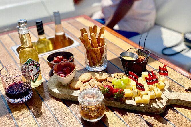 Amsterdam Small-Group Canal Cruise Including Snacks and Drinks - Amstel to the Red Light District Area: Storehouses and the City’s Edges